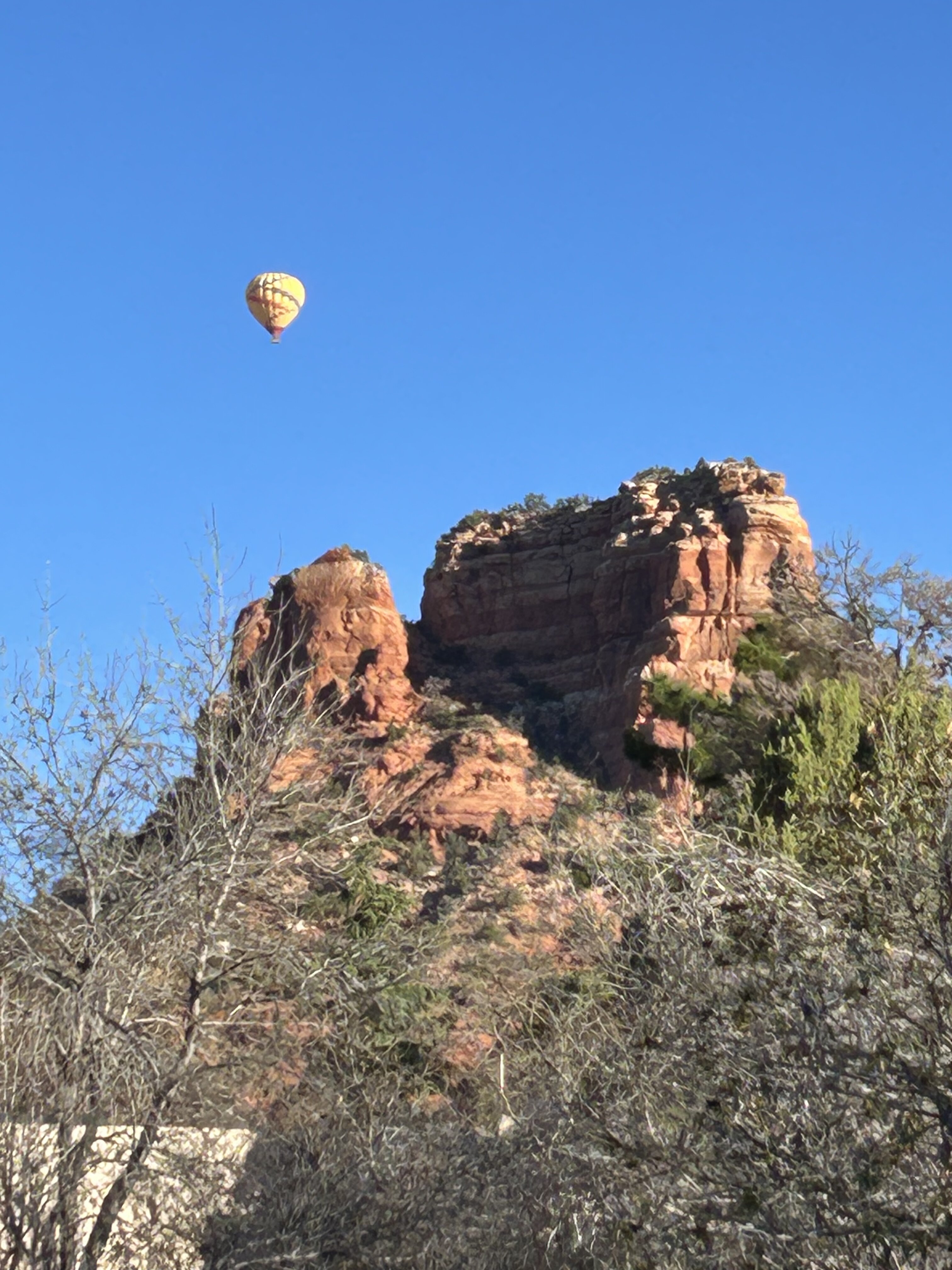 Yellow hot air balloons in a clear blue sky during a morning run