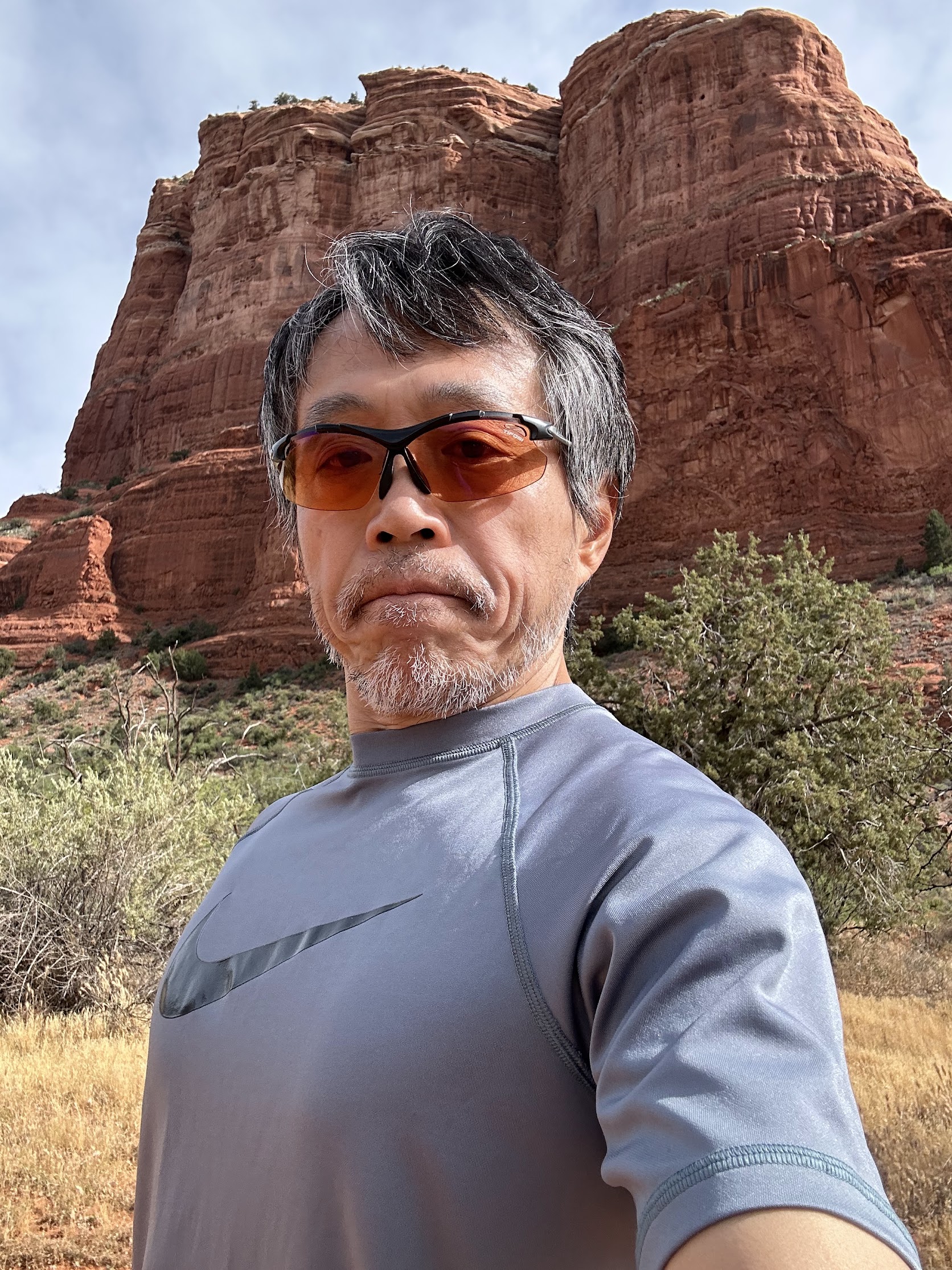 Ryu on a morning run with red sandstone cliffs behind him