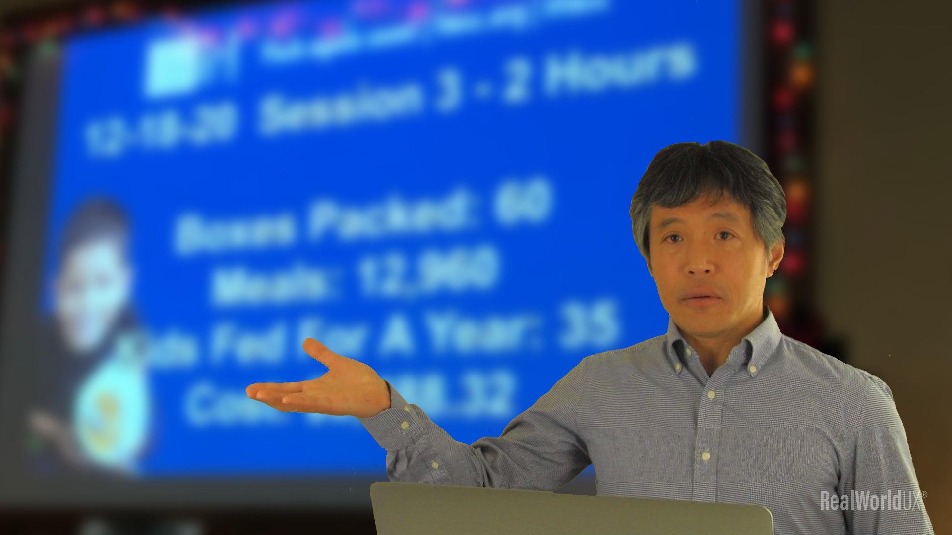 Author in front of a blurred image of a volunteer session result presentation screen